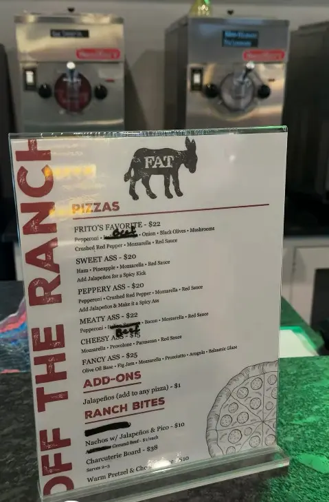 Off the Ranch pizza and ranch bites menu posted beside the Fat Ass logo at the counter